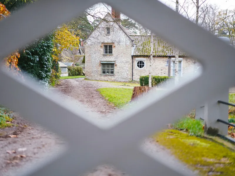 Period stone home set back behind a private gate