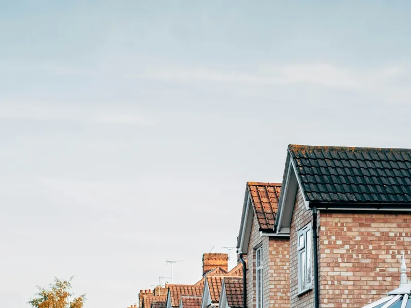 Brick terraced houses under a clear London sky